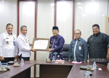 Bupati Tanjungjabung (Tanjab) Barat, Anwar Sadat, saat menerima penghargaan dari Kepala Kantor Kemenkumham Wilayah Jambi, Kamis (19/1/2023). (Foto Wahyu)